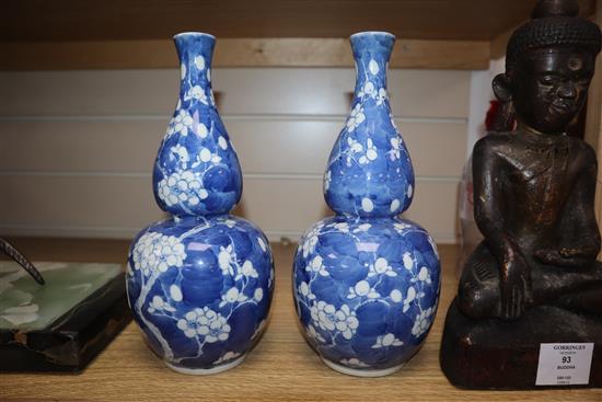 A pair of 19th century Chinese blue and white double gourd vases, Kangxi mark height 25cm